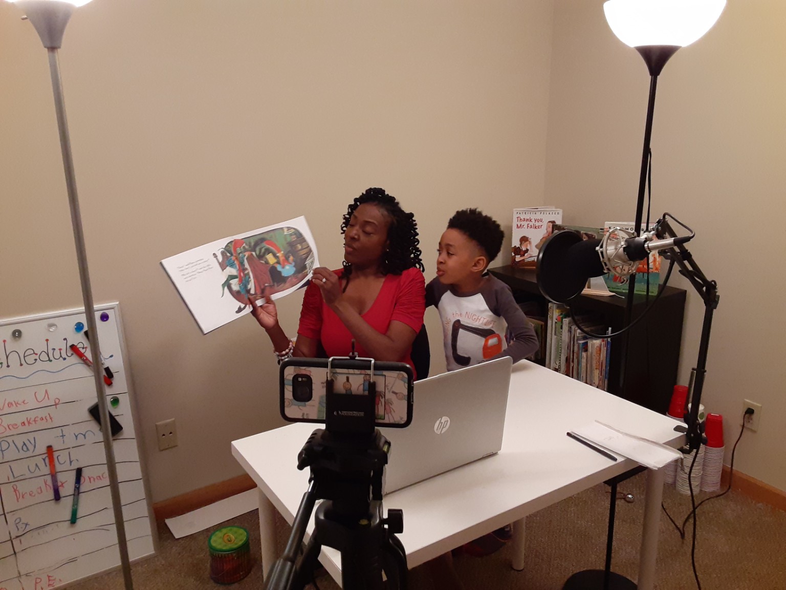 Tiffany reading a children's book with Myles while recording